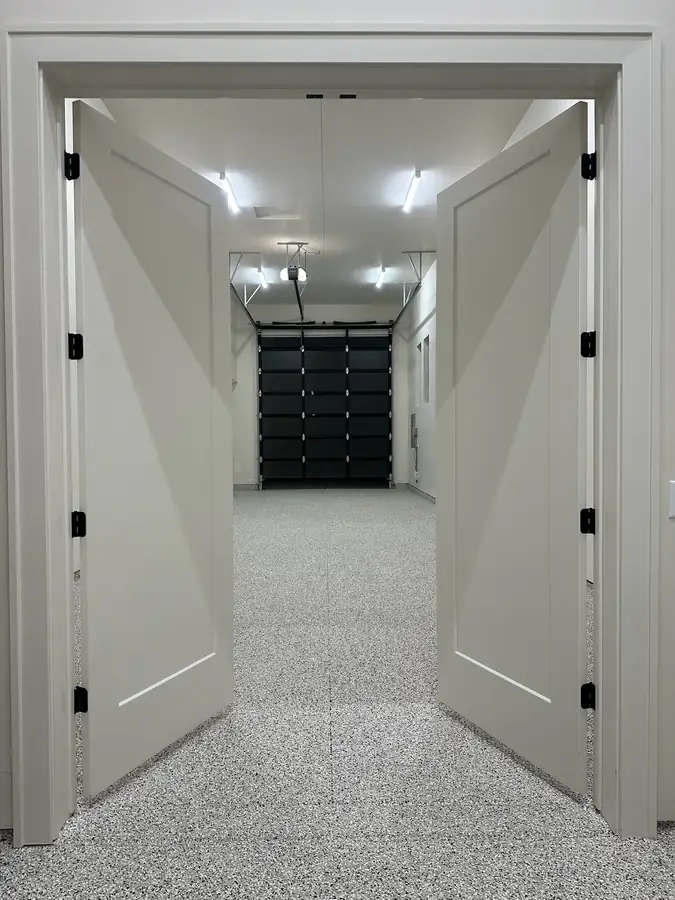 Double doors opening onto a flake coated shop