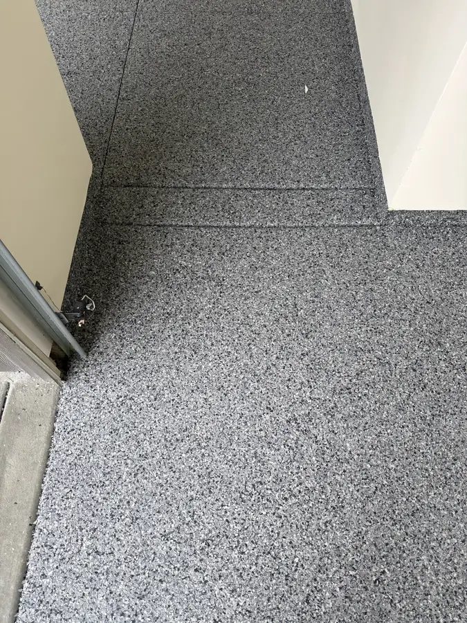 Flake floor along the garage door track