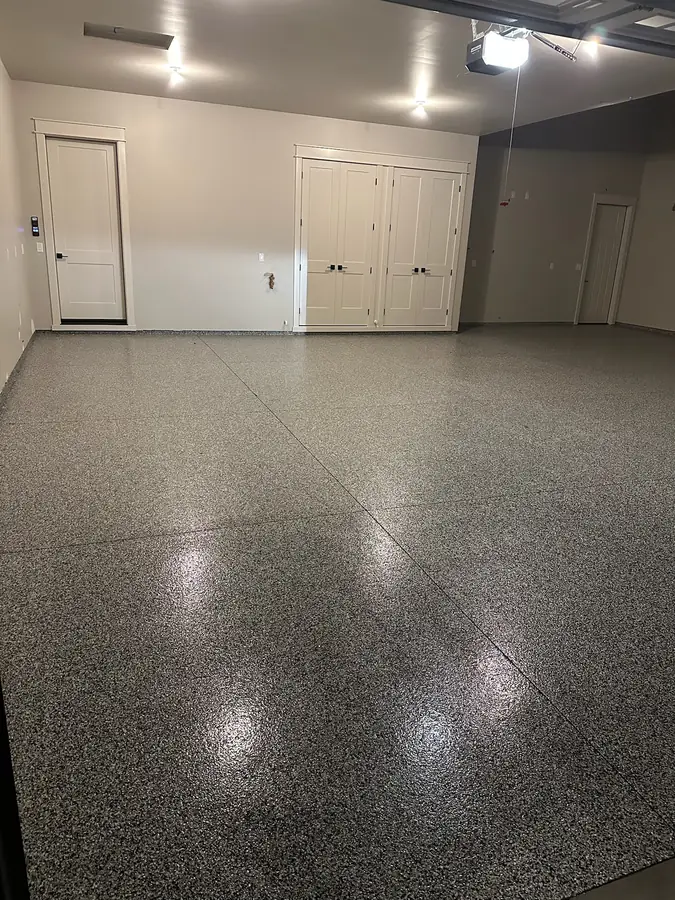 Shiny flake floor in a garage with cabinets