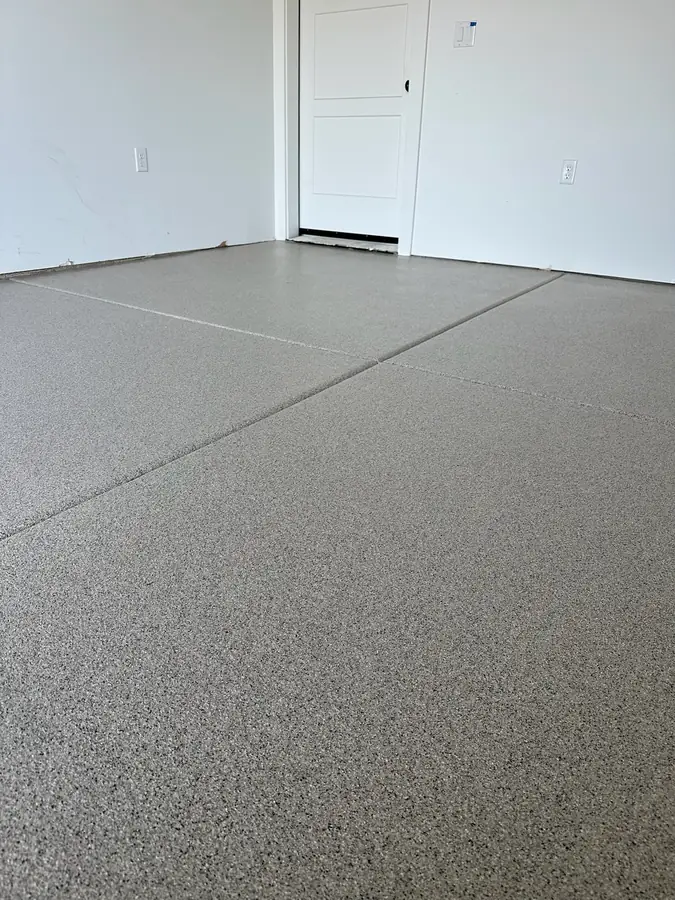 Gray flake floor meeting a white wall