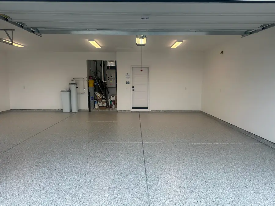 Wide garage with a light flake floor