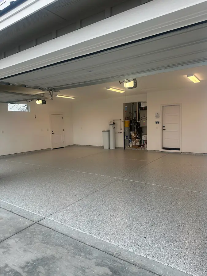 Garage with a fresh flake floor and the door open