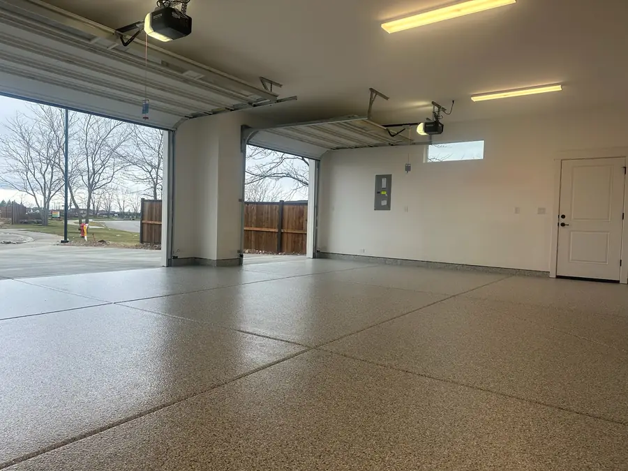 Garage floor coating with the doors open to the yard