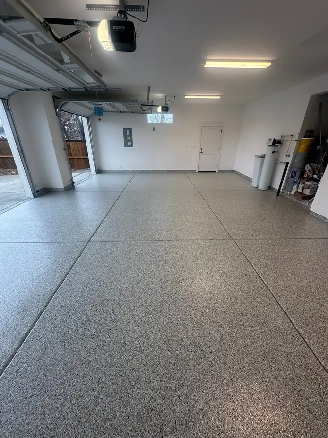 Long garage with a light flake floor